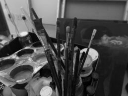 Paintbrushes and a paint-covered palette in the studio